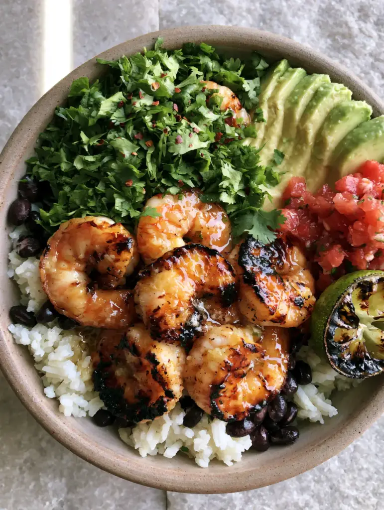 Cilantro Lime Shrimp Bowls with Garlic Butter and Charred Lime 2 Close-up of charred garlic butter shrimp with fresh cilantro and red pepper flakes in a ceramic bowl. (Cilantro Lime Shrimp Bowls)