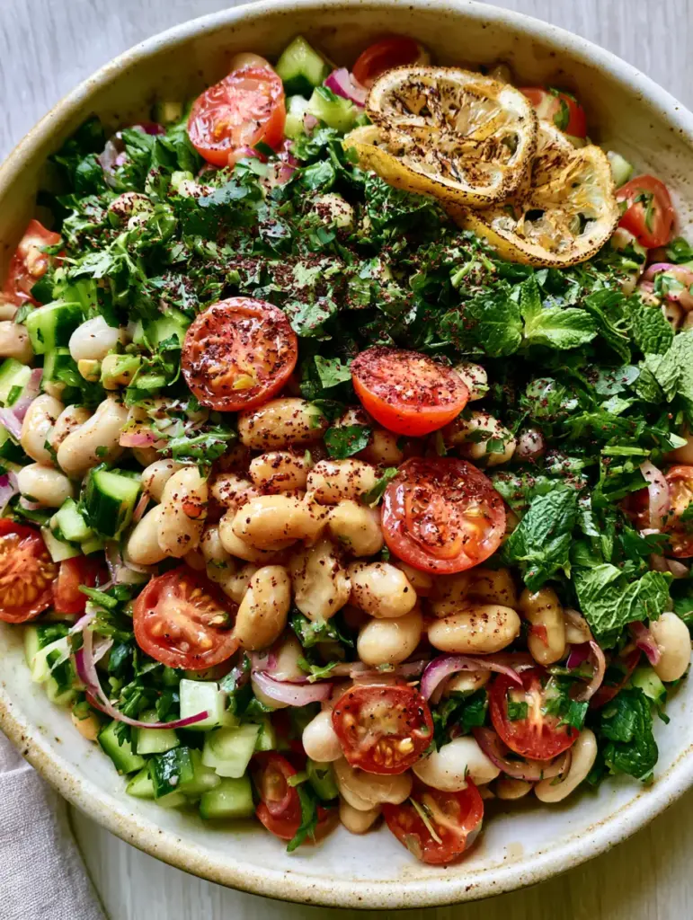White Bean Salad with Creamy Lemon-Tahini Dressing and Charred Lemons 2 Close-up of glossy white bean salad with creamy cannellini beans and fresh herbs in natural light.